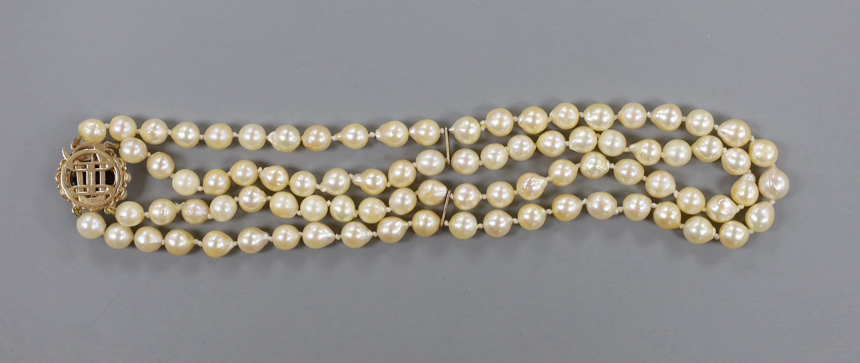 A twin strand cultured pearl necklace with a 9ct gold and garnet set clasp, 39cm.